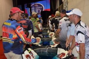 Anglers keep their fish in the water while waiting to weigh in.