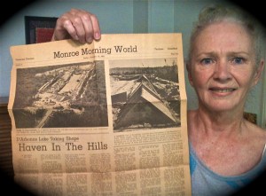 Jennifer Vick with a 1961 newspaper outlining plans for Lake D'Arbonne