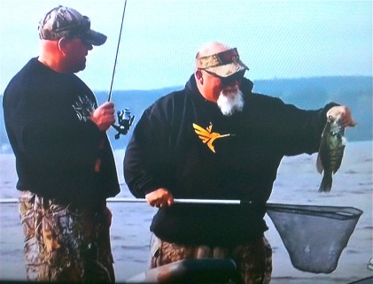 Kalonka and Godwin admire the one that didn't get away...or let the fishing rod get away...